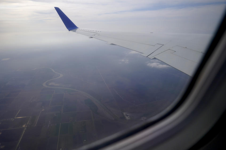 The Rio Grande, the barrier between the U.S. and Mexico, is visible from the window of a United Airlines regional jet carrying Celestina Ramirez, a migrant from Honduras, and her son Yancarlos Amaya, 5, Wednesday, March 24, 2021, in Harlingen, Texas. A few days ago, Yancarlos was walking along a muddy river bank after crossing the Rio Grande and landing on the U.S. side of the border with Mexico. Ramirez said they turned themselves in to U.S. Border Patrol officers and later spent hours in custody, a night under a bridge and three more days in a detention facility. (AP Photo/Julio Cortez)