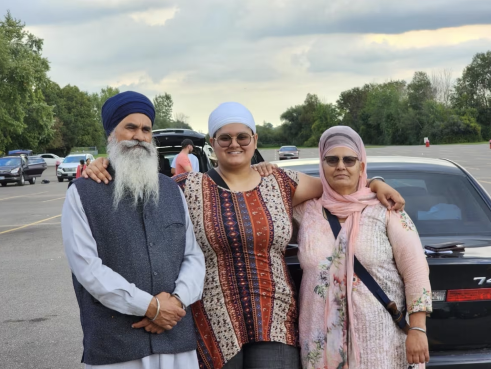 Sidhu, centre, with her father, Jagtar, and mother, Harbhajan, in September 2023. Sidhu says her father was a 'saint' and her mother was a kind woman who fed everyone who came to visit. (Submitted by Gurdit Sidhu)