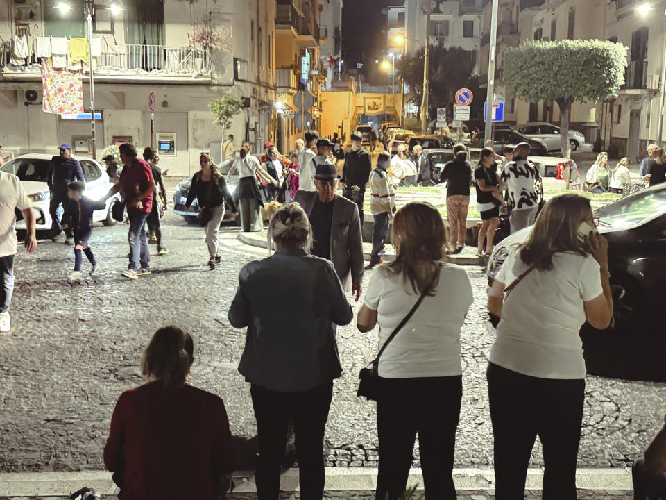 People gather in a street after an earthquake in Campi Flegrei, near Naples, Italy, Tuesday, May 20, 2024. The quake is the strongest ever recorded around the Phlegraean Fields, a sprawling area of ancient volcanic centers near the Tyrrhenian Sea that encompasses western neighborhoods of Naples and its suburbs, said Giuseppe De Natale, a vulcanologist of Italy’s INGV national geophysics and vulcanology center. (Alessandro Garofalo/LaPresse via AP)
