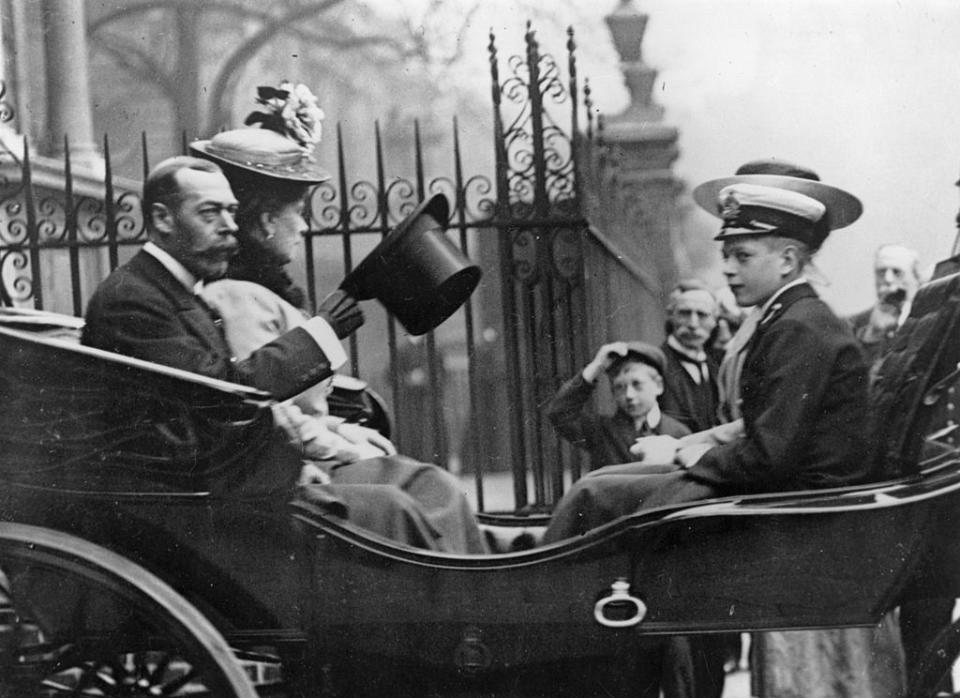 <p>King George V, Queen Mary, and their youngest son Prince John leave the Great Allied War Photographic Exhibition. </p>