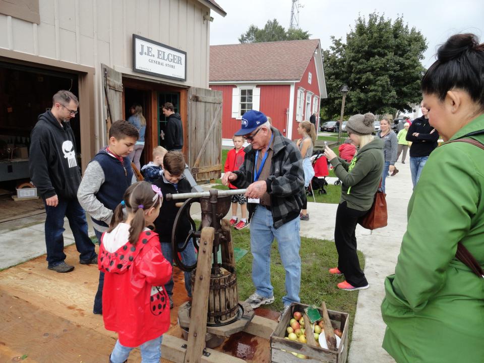 A honey and apple press is demonstrated at The New Berlin Historical Society’s Applefest.
