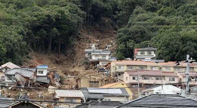 Rescue workers at the site of a landslide in a residential area. Photo: Getty