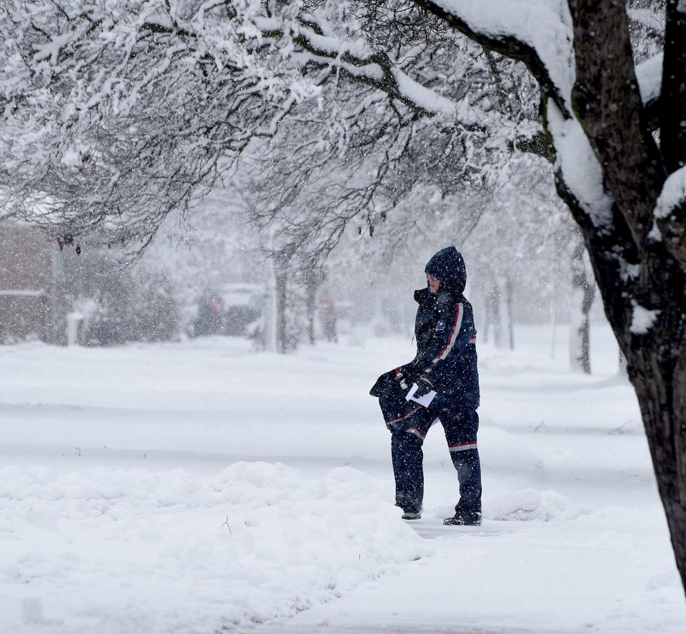 A mail carrier had to fight the elements of the season's first big snowfall Wednesday, Jan. 25, 2023, in Riverside Manor in Monroe.