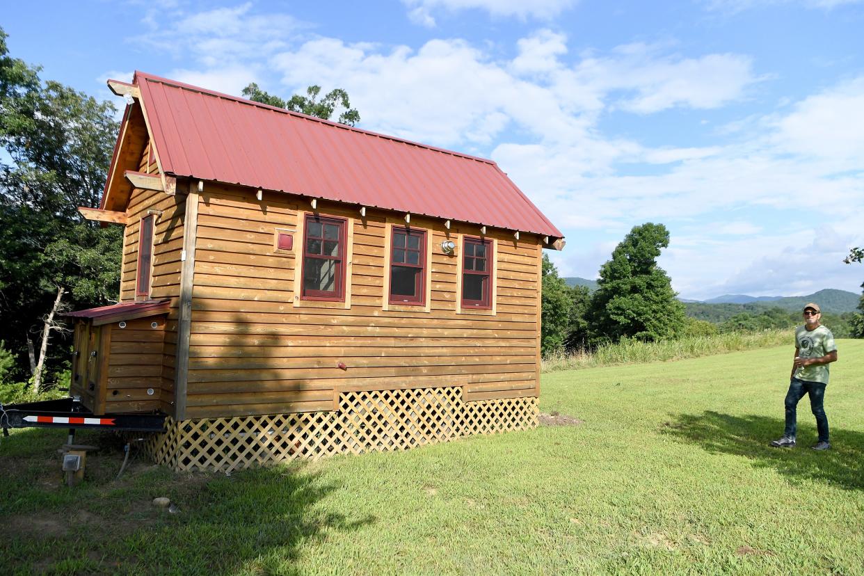 Pictured is Paint Rock Farm owner William "Tama" Dickerson beside the tiny house at the event venue property. On June 28, the Madison County Board of Commissioners voted to enstate a 6-month ban on issuing permits to commercial assembly businesses, such as event venues, hotels and motels.