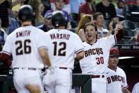 Arizona Diamondbacks' Jake McCarthy (30) celebrates runs scored by teammate Daulton Varsho (12) and Pavin Smith (26) against the Kansas City Royals during the fourth inning of a baseball game Monday, May 23, 2022, in Phoenix. (AP Photo/Ross D. Franklin)