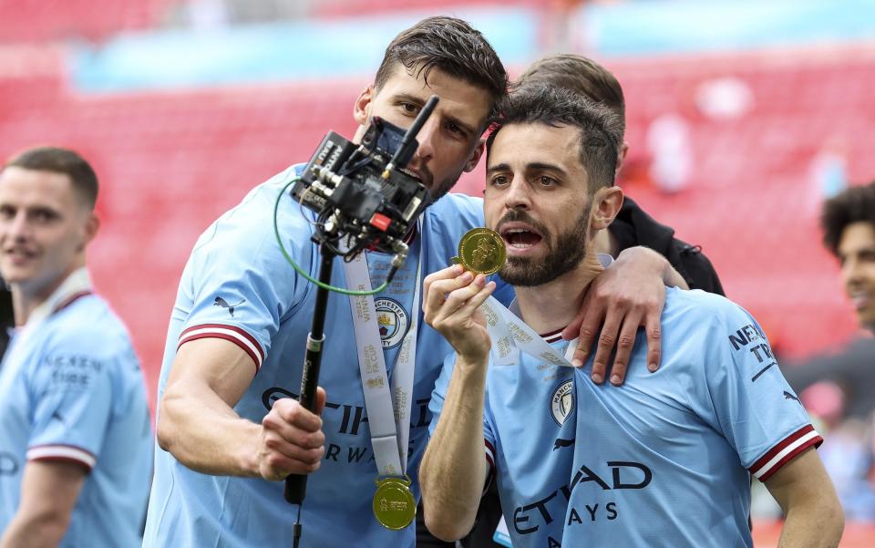 Ruben Dias and Bernado Silva of Manchester City after their side's 2-1 win during the FA Cup - BBC v ITV the real FA Cup final as sporting summer on TV begins - Getty Images/Robin Jones