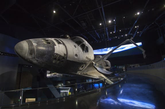 At the Kennedy Space Center Visitor Complex in Florida, the "Space Shuttle Atlantis" exhibit opens on June 29, 2013. The spacecraft will be the centerpiece of a 90,000-square-foot building in which visitors will see Atlantis as it appeared in s