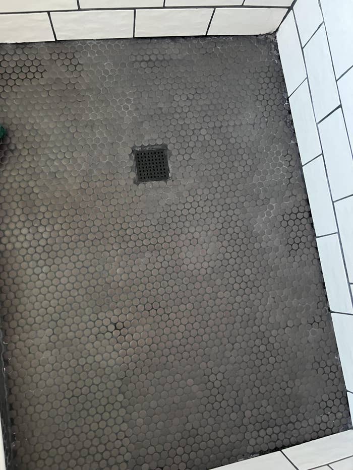 dirty penny tile floor in bathroom shower