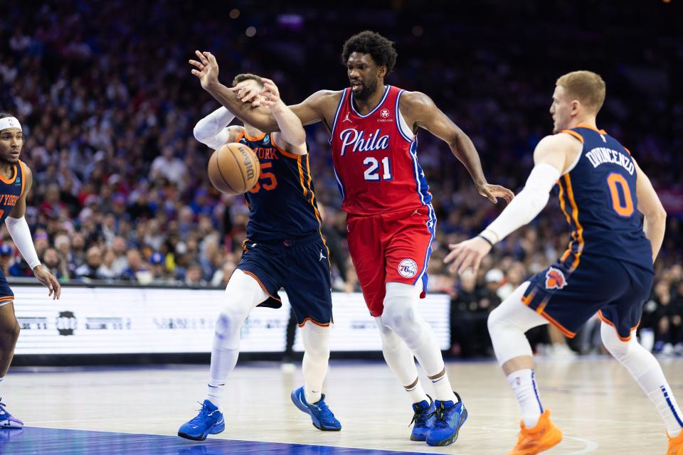 Apr 28, 2024; Philadelphia, Pennsylvania, USA; Philadelphia 76ers center Joel Embiid (21) loses the ball in front of New York Knicks center Isaiah Hartenstein (55) and Donte DiVincenzo during Game 4 of the 2024 NBA playoffs at Wells Fargo Center.
