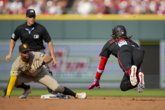 Cincinnati Reds' Spencer Steer (7) places a viking helmet on the head of  Elly De La Cruz (44) after Cruz hit a home run during the second inning of  a baseball game