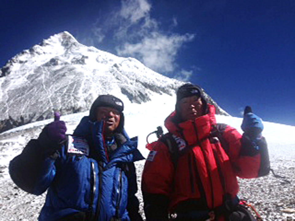 In this May 22, 2013 photo distributed by Miura Dolphins Co. Ltd., 80-year-old Japanese extreme skier Yuichiro Miura, right, and his son, Gota pose at their South Col camp at 8,000 meters (26,247 feet) before their departure for Camp 5 during their attempt to scale the summit of Mount Everest. Miura, who climbed Mount Everest five years ago, but just missed becoming the oldest man to reach the summit, was back on the mountain Wednesday to make another attempt at the title. (AP Photo/Miura Dolphins Co. Ltd.)  MANDATORY CREDIT