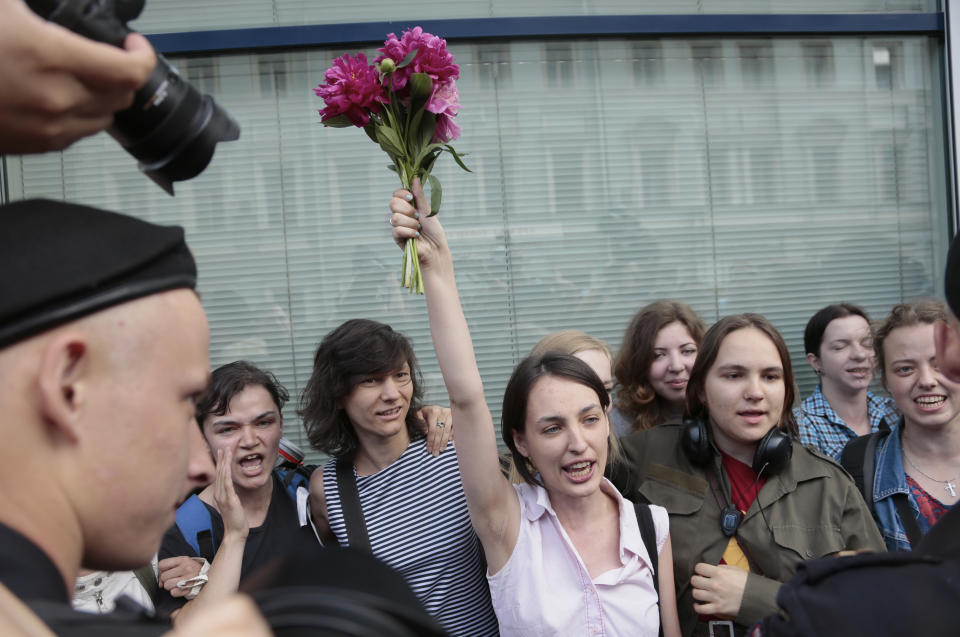 A police officer watches gay rights activists gather near the State Duma, Russia's lower parliament chamber, in Moscow, Russia, Tuesday, June 11, 2013. Protesters attempted to rally outside the Russian State Duma before what is expected to be a final vote on the bill banning "propaganda of nontraditional sexual relations." More than two dozen activists were detained in Moscow on Tuesday as they were protesting a bill that stigmatizes the gay community and bans the giving of information about homosexuality to children. (AP Photo/Ivan Sekretarev)