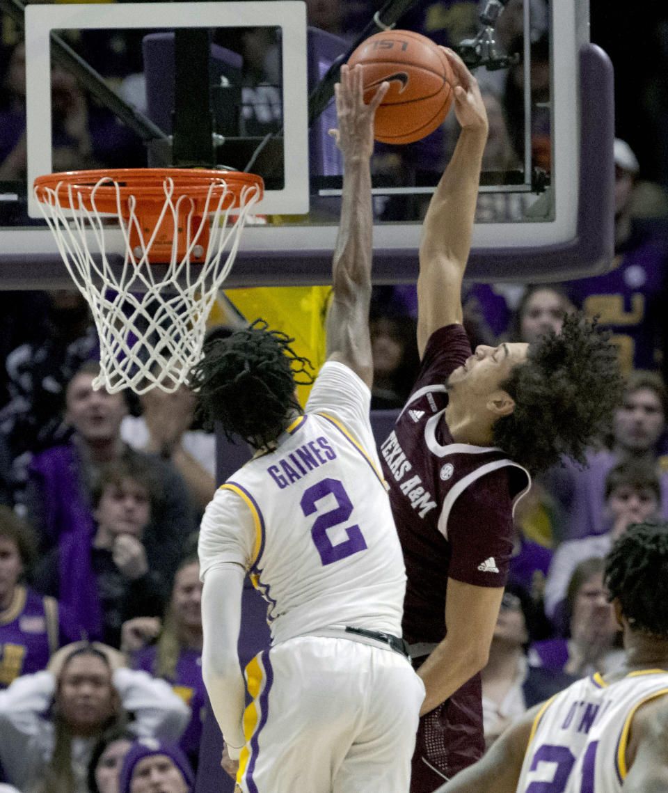 Texas A&M guard Marcus Williams (1) has his shot blocked by LSU guard Eric Gaines (2) during the second half of an NCAA college basketball game in Baton Rouge, La., Wednesday, Jan. 26, 2022. (AP Photo/Matthew Hinton)