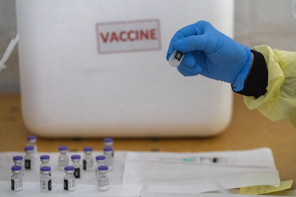 A pharmacist checks the batch number of the Pfizer-BioNTech COVID-19 Vaccines as she prepares doses at a pop-up COVID-19 vaccination site at the God's Battalion of Prayer Church, Wednesday, Feb. 3, 2021, in the Brooklyn borough of New York. SOMOS and Elderplan volunteer nurses are expected to vaccinate up to 500 older New Yorkers who attend the church or live in surrounding areas. (AP Photo/Mary Altaffer)