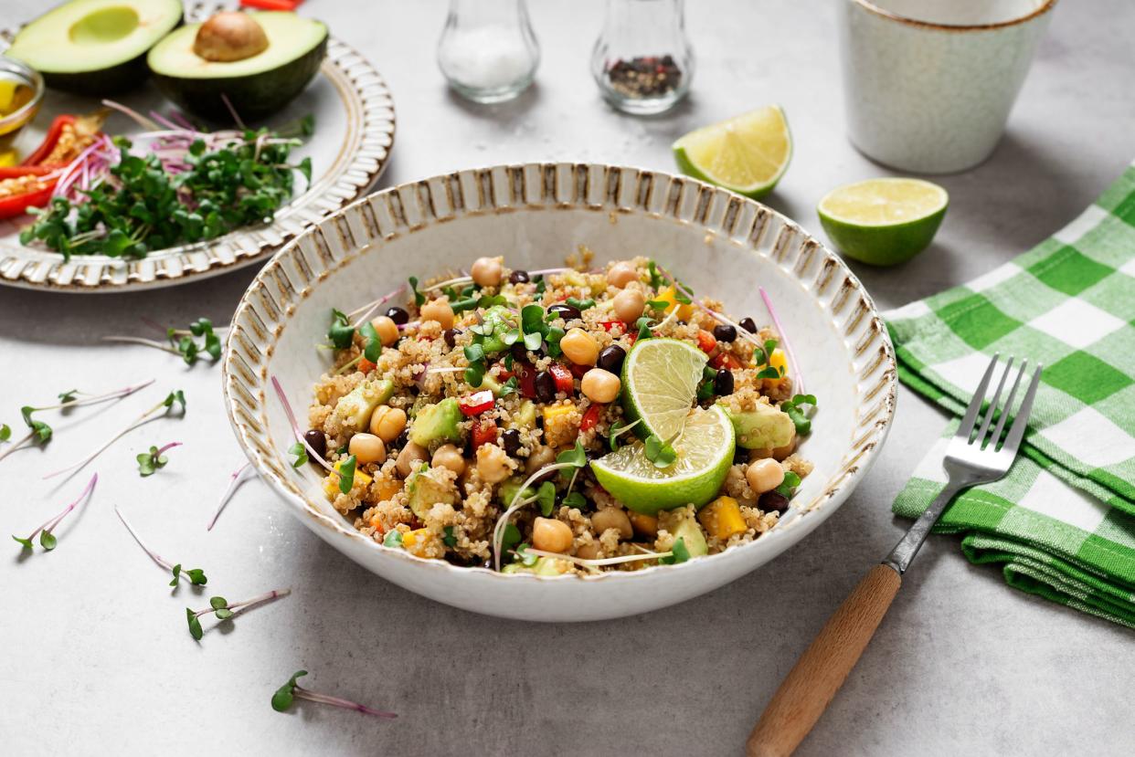 Healthy quinoa black bean salad with mango and avocado. Perfect for spring, summer, fall or winter. Gray stone background.