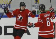 Canada's Curtis Lazar (L) celebrates his goal against Switzerland with teammate Griffin Reinhart during the third period of their IIHF World Junior Championship ice hockey game in Malmo, Sweden, January 2, 2014. REUTERS/Alexander Demianchuk (SWEDEN - Tags: SPORT ICE HOCKEY)