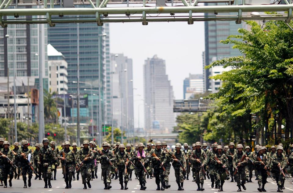 Thai soldiers march through Bangkok's financial district as they clash with anti-government protesters in May 2010.