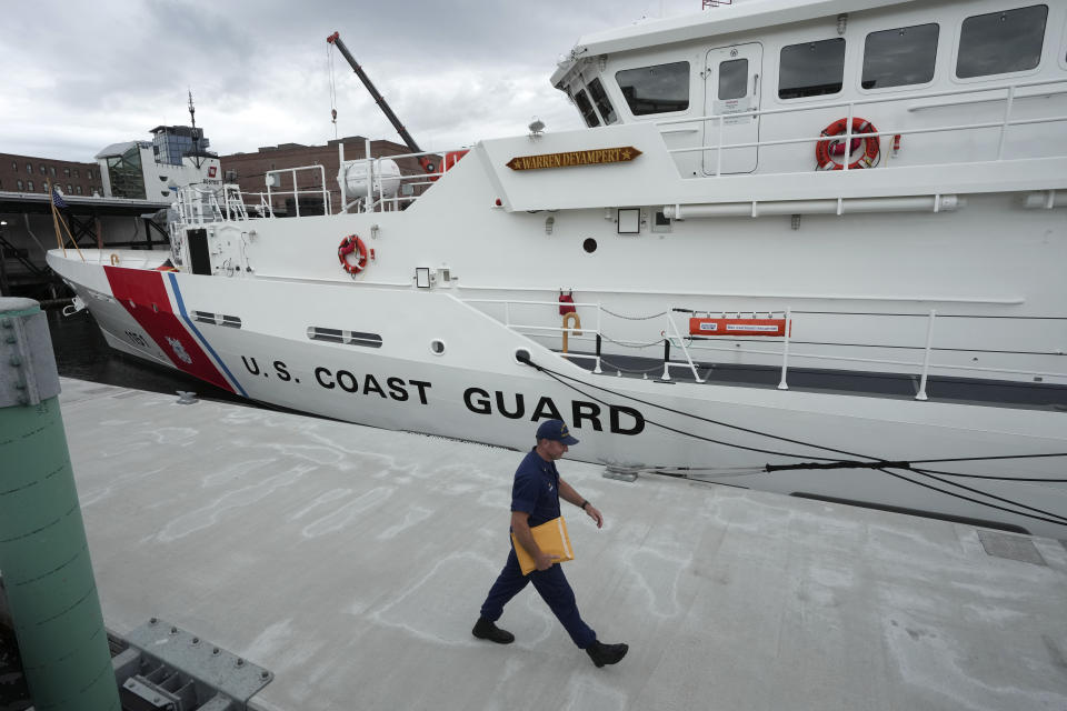 FILE - The U.S. Coast Guard Cutter Warren Deyampert is docked as a member of the Coast Guard walks past, Tuesday, June 20, 2023, at Coast Guard Base Boston, in Boston. Rescuers are racing against time to find the missing submersible carrying five people, who were reported overdue Sunday night, June 18, 2023. (AP Photo/Steven Senne, File)
