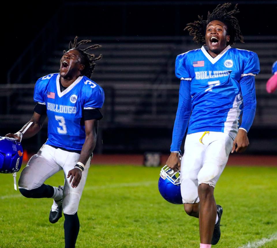 Brandywine's Crisdon Wright (3) and Jaylan Walker celebrate after the Bulldogs' 14-7 overtime win against Seaford at Brandywine, Friday, Oct. 20, 2023.