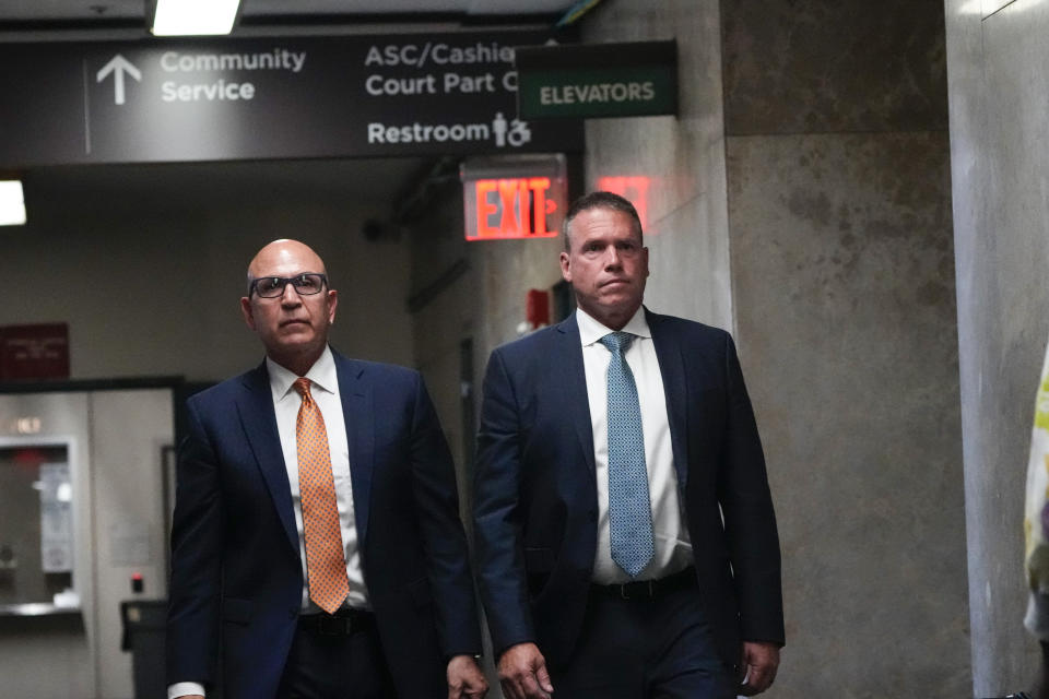 Howard Redmond, right, walks inside Manhattan Criminal Court Wednesday, Aug. 9, 2023, in New York. Redmond, the former head of police security for New York City's mayor, during the administration of Bill de Blasio, pleaded guilty on Wednesday to blocking an investigation into the misuse of city resources during the Democrat's failed presidential campaign. (AP Photo/Frank Franklin II)