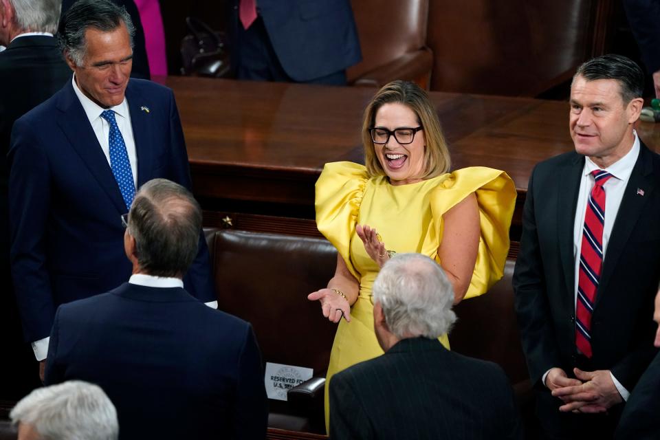 Sen. Kyrsten Sinema, Ind-Ariz., center, speaks with Sen. Mitt Romney, R-Utah, left, and Sen. Todd Young, R-Ind., right, and others, before President Joe Biden arrives to deliver his State of the Union speech to a joint session of Congress, at the Capitol in Washington on Feb. 7, 2023.
