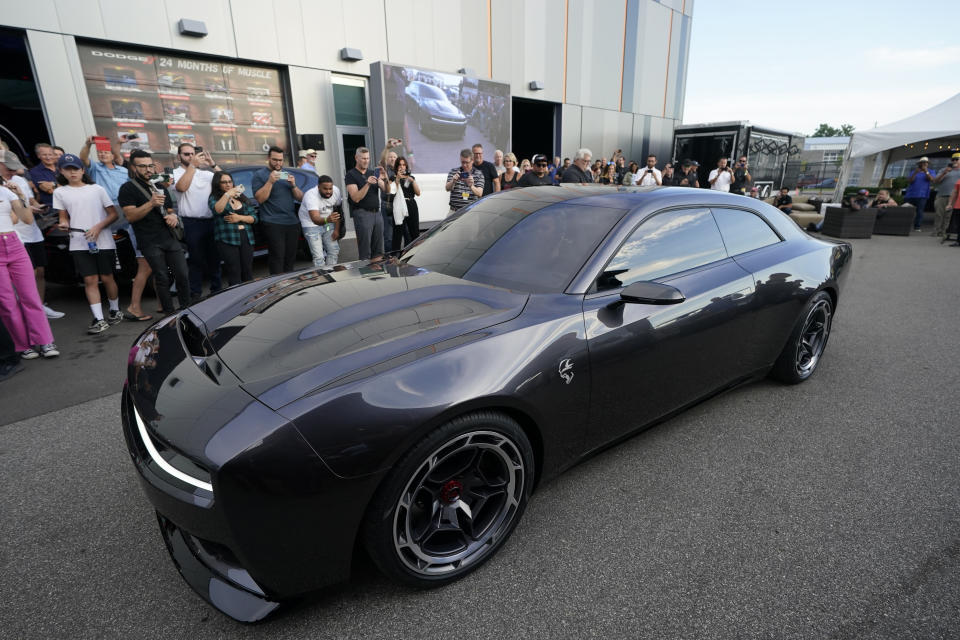 The Dodge Charger Daytona SRT concept is unveiled, Wednesday, Aug. 17, 2022, in Pontiac, Mich. Thundering gas-powered muscle cars will be closing in on their final Saturday night cruises in the coming years as automakers begin replacing them with super-fast cars that run on batteries. (AP Photo/Carlos Osorio)