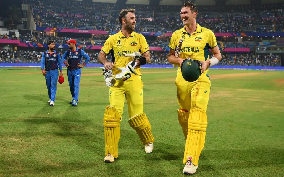 Glenn Maxwell of Australia celebrates with team-mate Pat Cummins after hitting a six for the winning runs, finishing unbeaten on 201 not out during the ICC Men's Cricket World Cup India 2023 between Australia and Afghanistan at Wankhede Stadium on November 07, 2023 in Mumbai, India