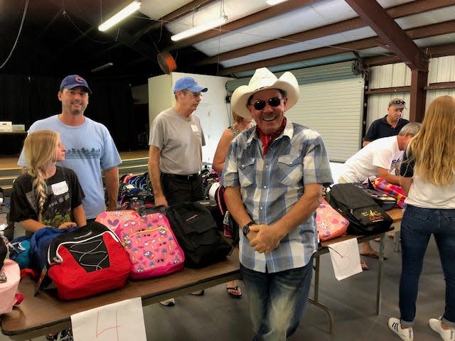 Jesse Zermeno (center), founder and president of Operation Hope, oversees the organization's 2018 school supplies giveaway in Fellsmere.