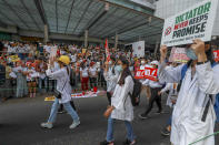 Myanmar doctors, supporters of "Civil Disobedience Movement", attend an anti-coup march in Yangon, Myanmar, Thursday, Feb. 25, 2021. Protesters against the military's seizure of power in Myanmar were back on the streets of cities and towns on Thursday as regional diplomatic efforts to resolve Myanmar's political crisis intensified Wednesday. (AP Photo)