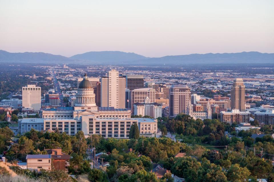 salt lake city, utah july 20, 2019 salt lake city skyline with utah state capitol in the foreground and wasatch mountain range in the background in the clear summer evening sunset sky