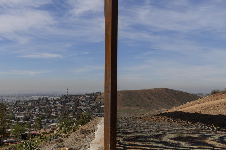 Tijuana, Mexico, left, and San Diego, Calif, right, are seen separated by the U.S. border fence, on Saturday, Dec. 22, 2018. The Trump administration’s decision to make asylum seekers wait in Mexico while their cases wind through clogged U.S. courts was announced with crucial details still unknown — a move that creates uncertainty along the border and possibly an incentive for people to cross illegally before the change take effect. (AP Photo/Daniel Ochoa de Olza)