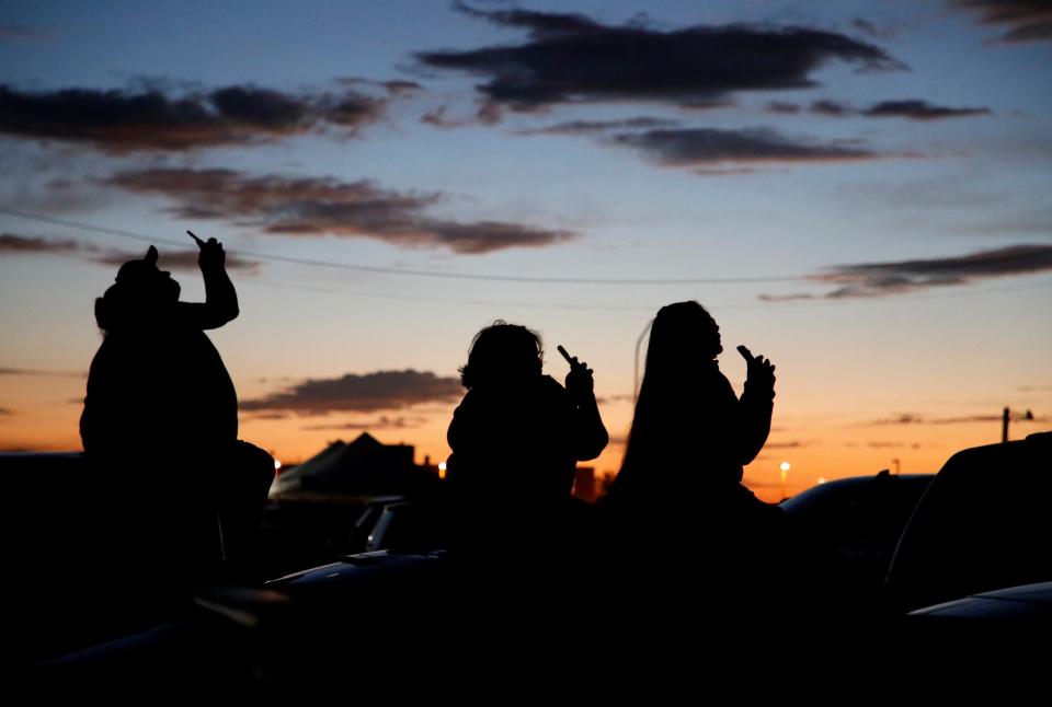 Spectators use their smartphones to film the fireworks show on July 1 in Shiprock.
