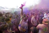 Revelers covered in colored corn starch celebrate during the 2014 Festival of Colors, Holi Celebration at the Krishna Temple Saturday, March 29, 2014, in Spanish Fork, Utah. Nearly 70,000 people are expected to gather starting Saturday at a Sri Sri Radha Krishna Temple in Spanish Fork for the annual two-day festival of colors. Revelers gyrate to music and partake in yoga during the all-day festival, throwing colored corn starch in the air once every hour. The Salt Lake Tribune reports that the large majority of participants are not Hindus, but Mormons. Thousands of students from nearby Brigham Young University come to take part in a festival that is drug and alcohol free. The event stems from a Hindu tradition celebrating the end of winter and the triumph of good over evil. (AP Photo/Rick Bowmer)