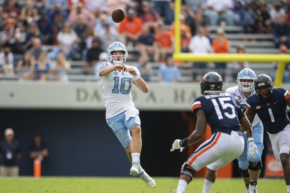 North Carolina quarterback Drake Maye (10) throws a pass against the Virginia defense during the first half of an NCAA college football game on Saturday, Nov. 5, 2022, in Charlottesville, Va. (AP Photo/Mike Caudill)