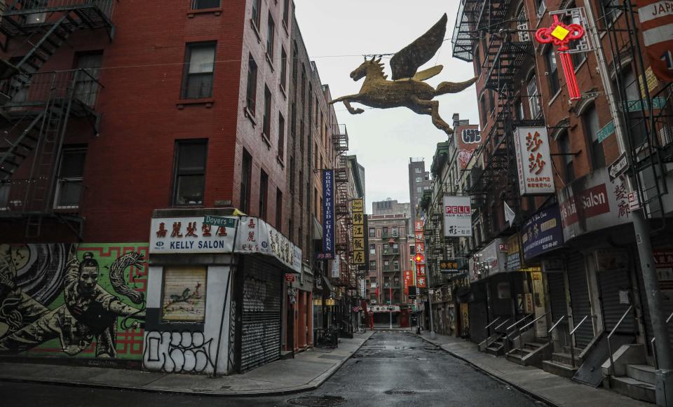 A street in New York's Chinatown is empty, the result of citywide restrictions calling for people to stay indoors and maintain social distancing in an effort to curb the spread of COVID-19, Saturday March 28, 2020, in New York. President Donald Trump says he is considering a quarantine affecting residents of the state and neighboring New Jersey and Connecticut amid the coronavirus outbreak, but New York Gov. Andrew Cuomo said that roping off states would amount to "a federal declaration of war." (AP Photo/Bebeto Matthews)