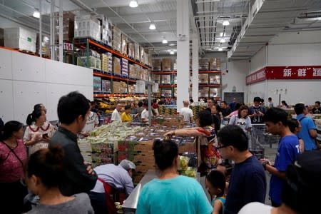 People visit a U.S. hypermarket chain Costco Wholesale Corp store in Shanghai