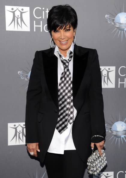 Kris Jenner not only wears the pants in the family, she also wears the tie. And the required blingy accessory.