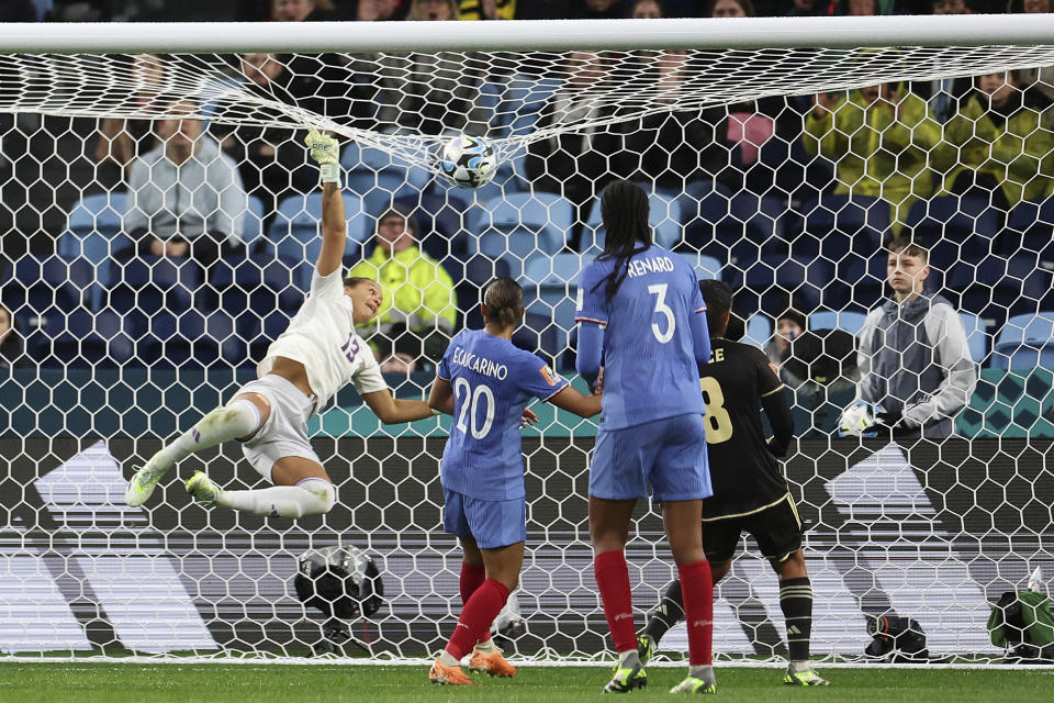 Jamaica's goalkeeper Rebecca Spencer leaps at the ball during the Women's World Cup Group F soccer match between France and Jamaica at Sydney Football Stadium in Sydney, Australia, Sunday, July 23, 2023. (AP Photo/Sophie Ralph)