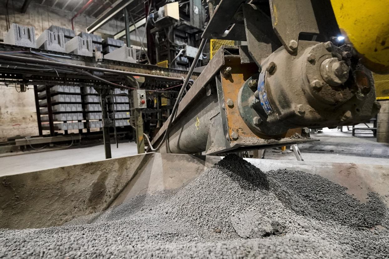 Excess material from freshly made concrete blocks, created with liquid carbon dioxide as an ingredient, is collected for reprocessing at the Glenwood Mason Supply Company, Tuesday, April 18, 2023, in the Brooklyn borough of New York. New York is forcing buildings to clean up, and several are experimenting with capturing carbon dioxide, cooling it into a liquid and mixing it into concrete where it turns into a mineral. (AP Photo/John Minchillo)