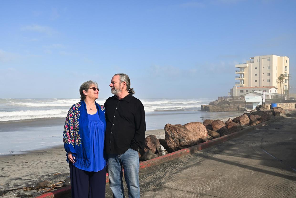 <span>Renee and Jym Varnadore walk near their beach condo in Rosarito Beach, Baja California, Mexico, on 25 March 2024.</span><span>Photograph: Carlos Moreno/The Guardian</span>