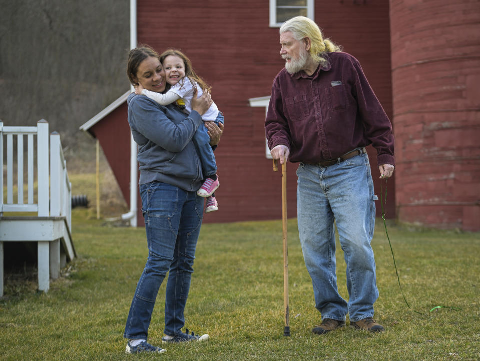 From left, Laurel and Lennon Linkroum, are pictured with Harold Koster, Laurel's father and Lennon's grandfather, respectively, at Koster's farm, Wednesday, March 13, 2024, in Whitney Point, N.Y. The Kosters were asked by Texas-based Southern Tier Energy Solutions to lease their land to extract natural gas by injecting carbon dioxide into the ground, which they rejected and are opposed to. (AP Photo/Heather Ainsworth)