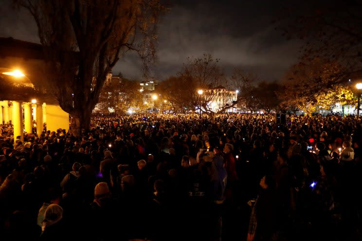 People gather during a Monday night vigil for the victims of the warehouse fire in Oakland, Calif. (Photo: Stephen Lam/Reuters)