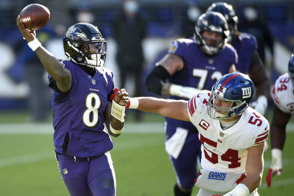 Baltimore Ravens quarterback Lamar Jackson (8) looks to throw a pass as New York Giants inside linebacker Blake Martinez (54) applies pressure during the first half of an NFL football game, Sunday, Dec. 27, 2020, in Baltimore. (AP Photo/Gail Burton)