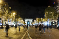 FILE - Spectators gather to attend the Champs Elysee Avenue illumination ceremony for the Christmas season, in Paris, Nov. 20, 2022. In cities across Europe, officials are wrestling with a choice this Christmas. Dim lighting plans to send a message of energy conservation and solidarity with citizens squeezed by both higher energy costs and inflation or let the lights blaze in a message of defiance after two years of pandemic-suppressed Christmas seasons, creating a mood that retailers hope loosen holiday purses. (AP Photo/Lewis Joly, File)