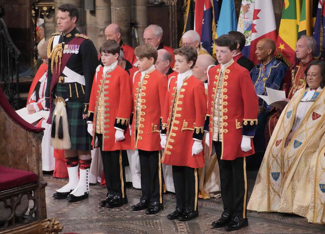 <p>JONATHAN BRADY/POOL/AFP via Getty</p> Lieutenant Colonel Johnny Thompson stands with King Charles' pages, including Prince George, at the coronation ceremony at Westminster Abbey in London on May 6, 2023.