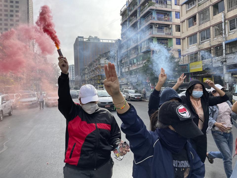 Several members of a youth group hold a flash mob rally to protest against the military government of Senior Gen. Min Aung Hlaing in Pabedan township in Yangon, Myanmar Tuesday, Nov. 30, 2021. (AP Photo)