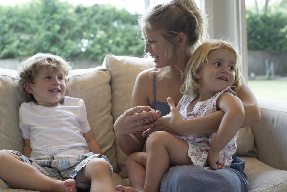 Image of babysitter holding two children