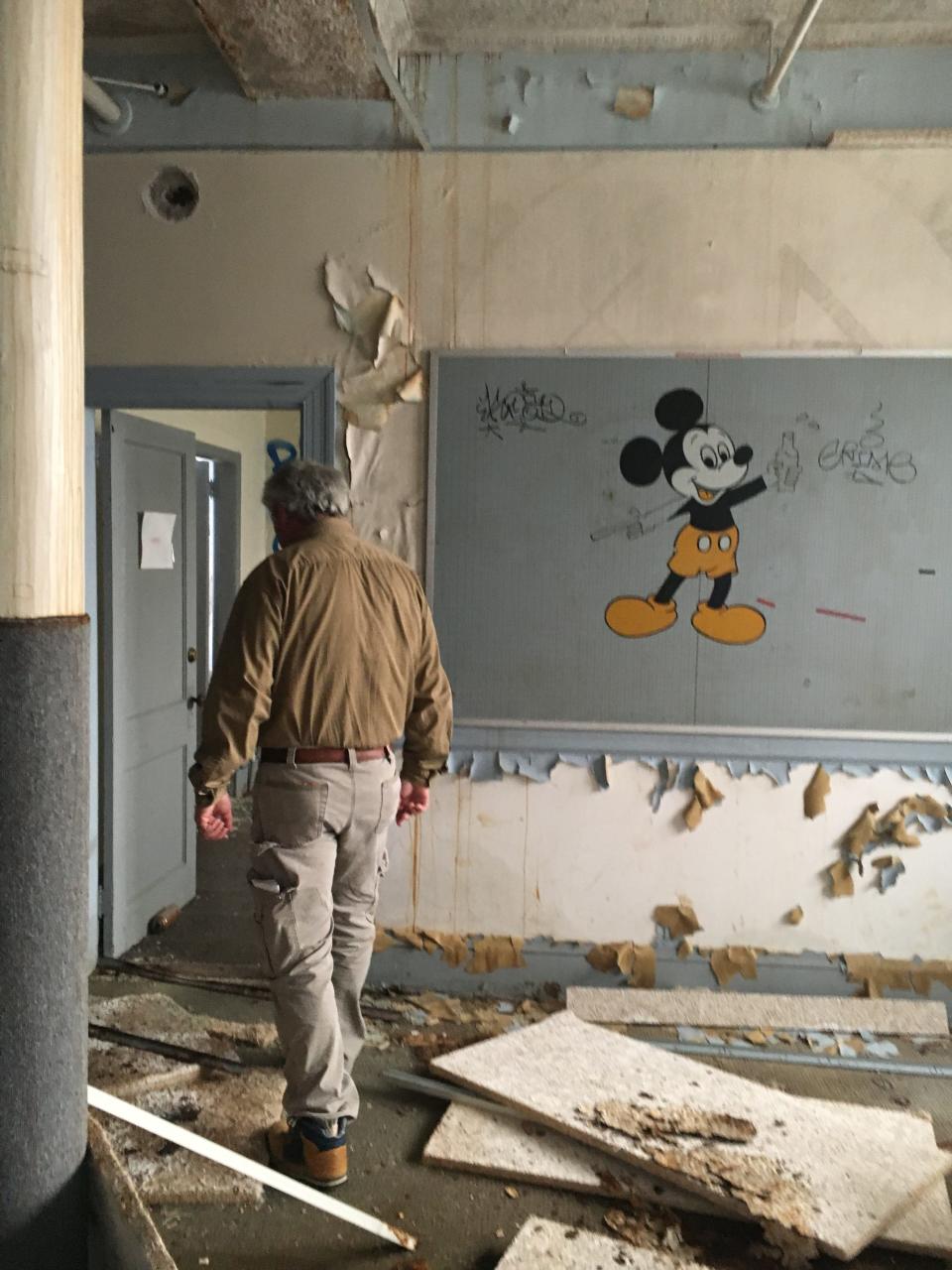 Minimum Housing Director Faust Fiore does a walk through at the former Silvia School in this file photo. [Herald News photo | Jo Goode]