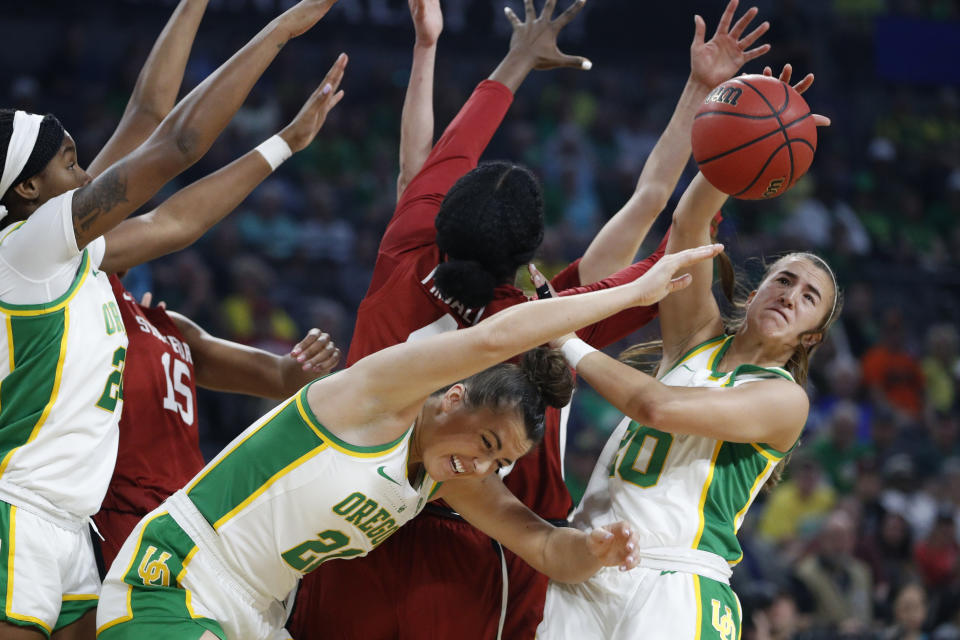 Oregon's Sabrina Ionescu, right, and Oregon's Erin Boley (21) battle for a rebound against Stanford during the first half of an NCAA college basketball game in the final of the Pac-12 women's tournament Sunday, March 8, 2020, in Las Vegas. (AP Photo/John Locher)