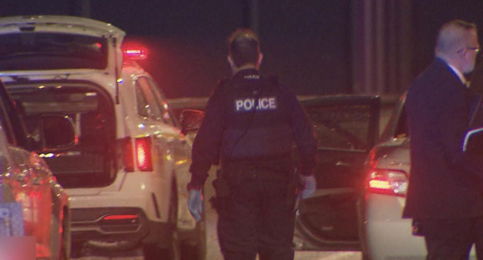 Police officers by the side of cars in Adelaide.